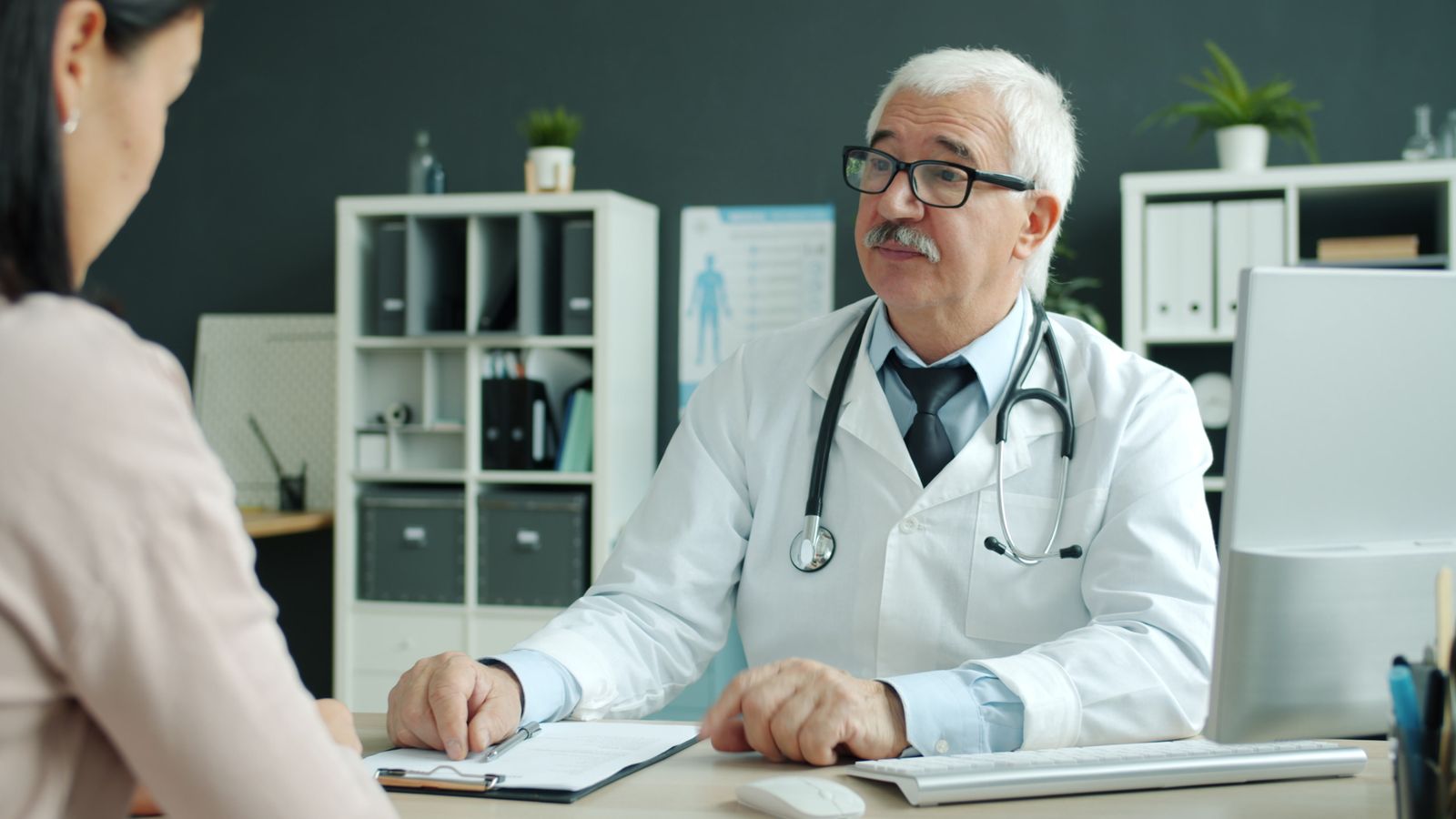 A clinician talking through a report with a patient