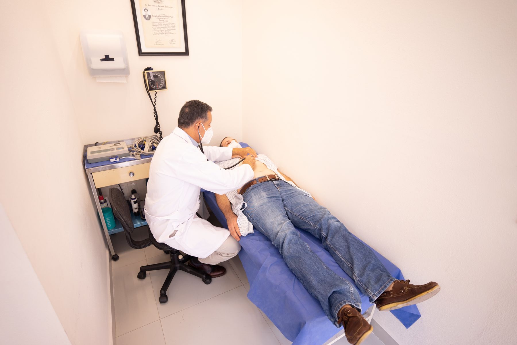 A clinician examining a patient with a stethoscope
